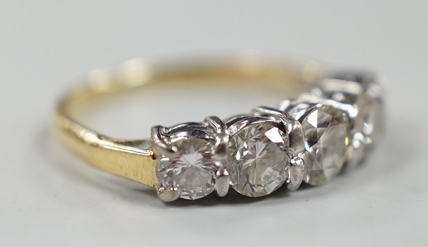 A gold and graduated five stone diamond set half hoop ring, size G/H, gross weight 2.7 grams.